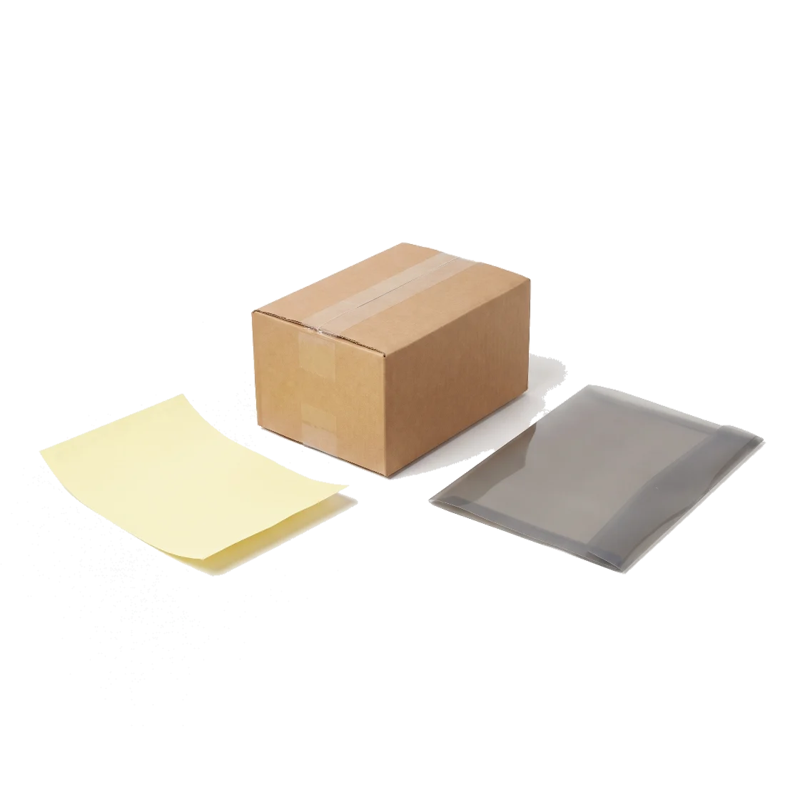 A sealed brown cardboard parcel on a counter beside a blank yellow carbon-copy slip and a clear document wallet.