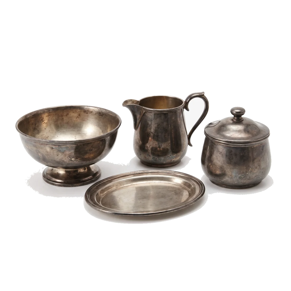Tarnished sterling silver hollowware: a footed bowl, a creamer jug, a lidded pot and a plain oval tray.