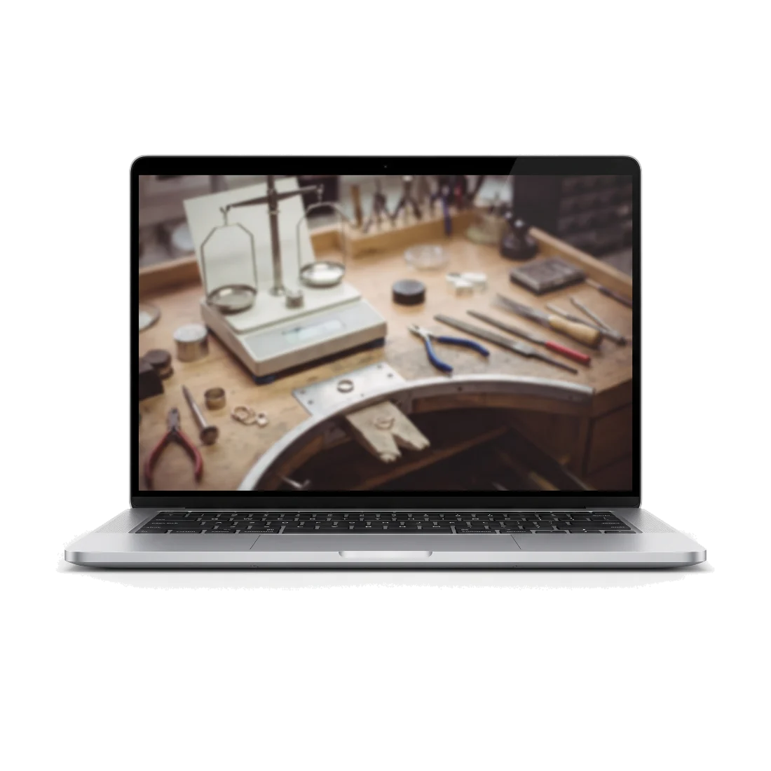 An open laptop showing a view of a jeweller's workbench with a precision balance and hand tools on it.
